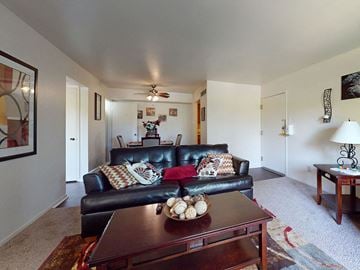 St. Louis apartment for rent - a living room with a leather couch and a coffee table