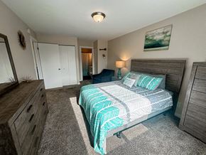 Muskegon apartment for rent - a bedroom with a bed and a dresser