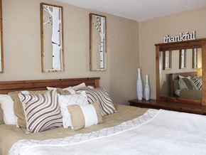 Charlack townhouse for rent - a bedroom with a large bed with pillows and a mirror on the wall