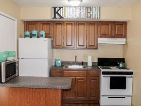 Charlack townhouse for rent - apartment kitchen with wood cabinets and white appliances