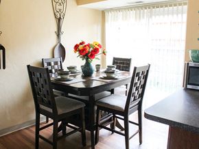 Charlack townhouse for rent - a dining room table with a vase of flowers on top of it