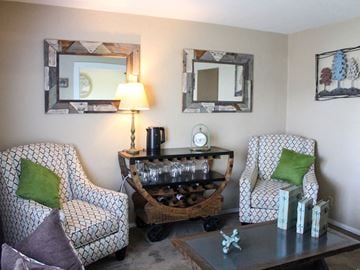 Charlack townhouse for rent - a living room with chairs and a table and a mirror