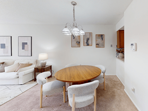 Ballwin townhouse for rent - A modern dining room with a wooden table and chairs.