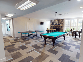 Ballwin townhouse for rent - A room with a pool table and a fireplace.