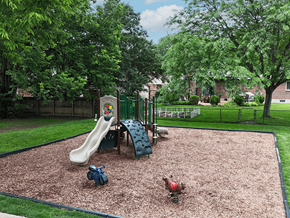 Sappington townhouse for rent - A playground with a slide, swings, and a seesaw.