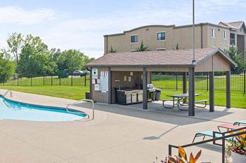 Poolside sundeck and outdoor kitchen