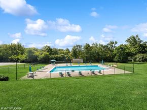 West Chester apartment for rent - a swimming pool in the middle of a grass field with chairs around it