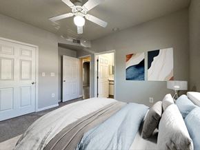 Fayetteville apartment for rent - a bedroom with a bed and a ceiling fan