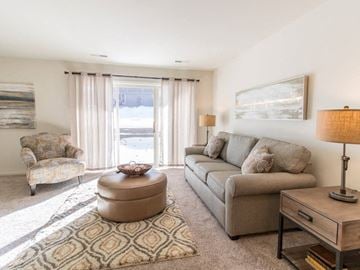 Grand Blanc apartment for rent - a living room with a couch and a chair and a table