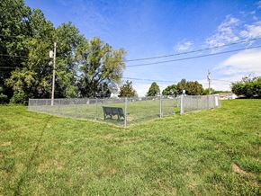 Sioux City apartment for rent - a bench sitting in the middle of a lush green field