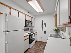 Topeka townhouse for rent - a kitchen with a stove refrigerator and sink
