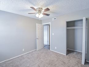 Wichita townhouse for rent - an empty room with a ceiling fan and a door to a closet