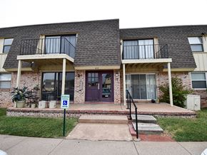 Wichita townhouse for rent - the front of a brick house with a purple door