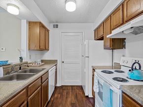 Kansas City apartment for rent - apartment kitchen with a stove, sink, and a refrigerator