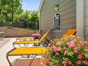 Kansas City apartment for rent - a patio with benches by the pool