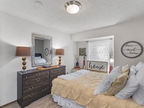 Lenexa apartment for rent - a bedroom with a bed and dresser