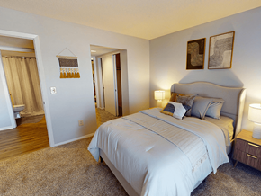 Ofallon townhouse for rent - A bedroom with a large bed and two lamps.