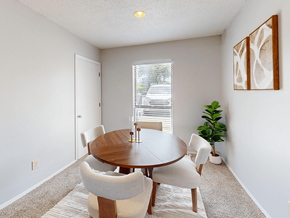 Ofallon townhouse for rent - A dining room with a round table and chairs.