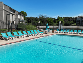 Ofallon townhouse for rent - A swimming pool with blue water and lounge chairs.