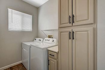 A small laundry room with a washer and dryer.