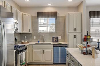 A kitchen with a stove top oven and a dishwasher.