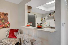 Las Vegas apartment for rent - A kitchen with a white counter and a painting of a camel on the wall. at Solstice Apartment Homes, Nevada