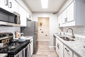 Durham apartment for rent - a kitchen with white cabinets and stainless steel appliances