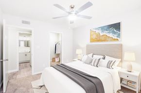 Durham apartment for rent - a bedroom with a large bed and a ceiling fan