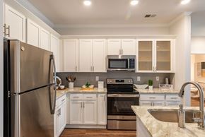 Greensboro apartment for rent - a kitchen with stainless steel appliances and white cabinets