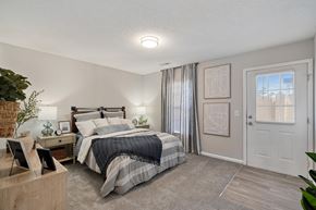 Greenville apartment for rent - A bedroom with a bed, nightstand, and window.
