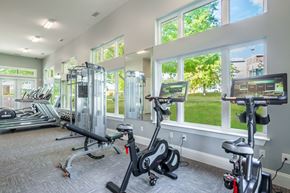 Greensboro apartment for rent - A gym with treadmills, elliptical machines, and stationary bikes.