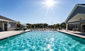 Greenville apartment for rent - A sunny day at the outdoor pool with people enjoying the water.