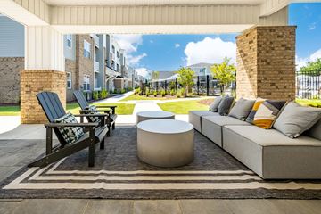 Greenville apartment for rent - the preserve at ballantyne commons living room with couches and tables