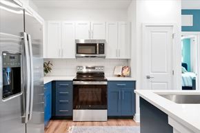 Fruitland Park apartment for rent - A kitchen with white cabinets and a blue island.
