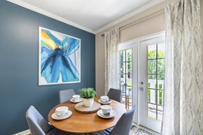 Birmingham apartment for rent - a dining room with a table and chairs and a door to a balcony
