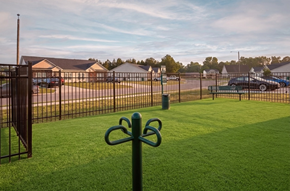 Greenville townhouse for rent - A black metal fence with a green post in front of a grassy area.