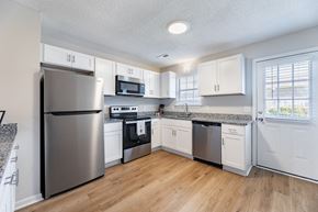 Winterville apartment for rent - A kitchen with a refrigerator, microwave, oven, and sink.