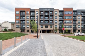 Cary apartment for rent - A Meridian building with a parking garage in front.
