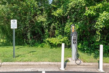 Durham apartment for rent - An electric vehicle charging station is located next to a sign that says "ELECTRIC VEHICLE CHARGING ONLY".