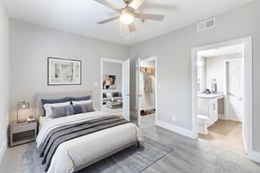 Durham apartment for rent - A bedroom with a large bed and a ceiling fan.