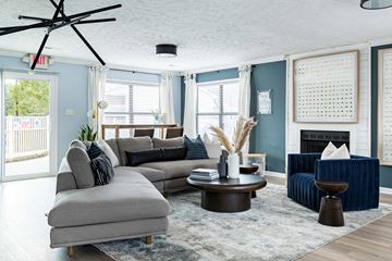 Spring Lake apartment for rent - a living room with blue walls and a gray couch