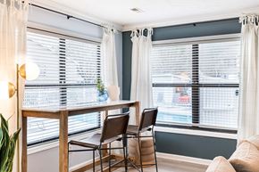 Spring Lake apartment for rent - a dining room with two windows and a table with three chairs