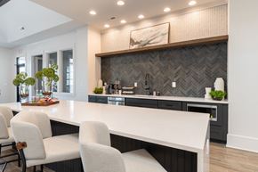 Fayetteville apartment for rent - a kitchen with a large white counter top and chairs