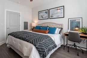 Fayetteville apartment for rent - a bedroom with a bed and a desk with a chair
