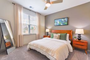 Burlington apartment for rent - a bedroom with a bed and a large window