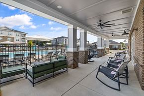 Kernersville apartment for rent - the pool area at the preserve at polo terrace with lounge chairs and tables