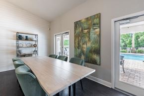 Port Orange apartment for rent - a dining room with a table and chairs and a sliding glass door to a pool