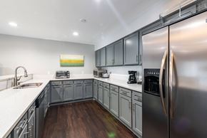 Port Orange apartment for rent - a modern kitchen with stainless steel appliances and white counter tops