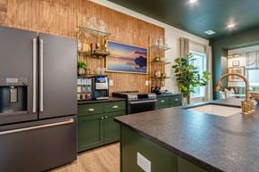 High Point apartment for rent - Inside Clubhouse with a Modern Kitchen with Dark Green Cabinets and a Wooden Backsplash.