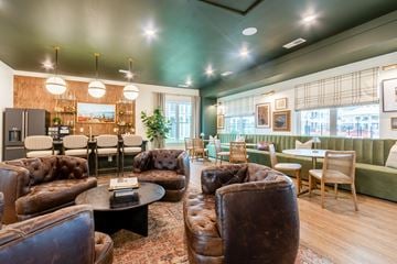 High Point apartment for rent - A living room with brown leather couches and a black coffee table.